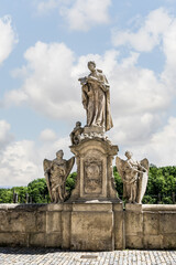 Obraz premium Stone statue of King Ferdinand III of Castile stands on parapet of Baroque Gallery in Kutna Hora in Czech Republic