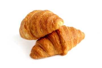 There are two fresh croissants on a white background.