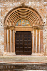 Closeup of the Holy Door located outside the Basilica of Santa Maria di Collemaggio in L’Aquila, Abruzzo, Italy.