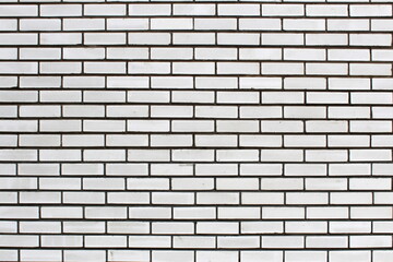 Texture of a wall made of red clay bricks, not laid neatly.