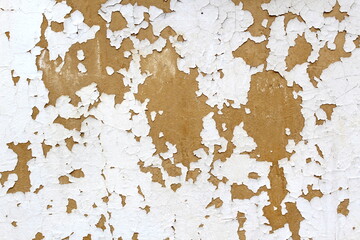 Abstract texture of old wall with peeling paint in brown and white colors.