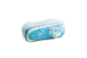 On a white background lies a striped blue soap with foam.