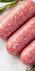Three Raw Bratwurst Sausages Knot Style Garnished with Fresh Rosemary Sprigs Showcasing Their Pink Speckled Texture
