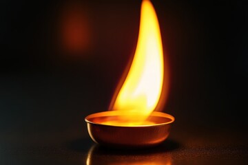 A small cup filled with liquid and a vibrant dancing flame