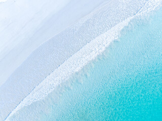 Drone view of white sand beach and azure sea. Water on the sea coast. Summer vacation and holiday....