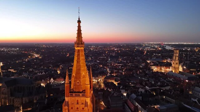 Beautiful aerial view of Brugge, Belgium at sunset highlighting historic architecture and tranquil city life