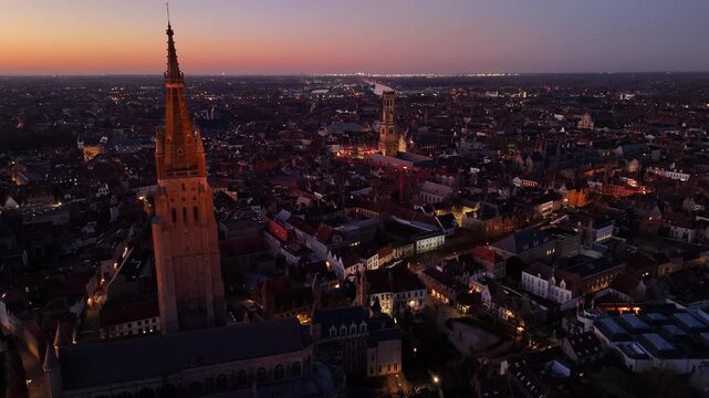 Bird's eye view of Brugge, Belgium showcasing historic architecture and vibrant sunset skyline