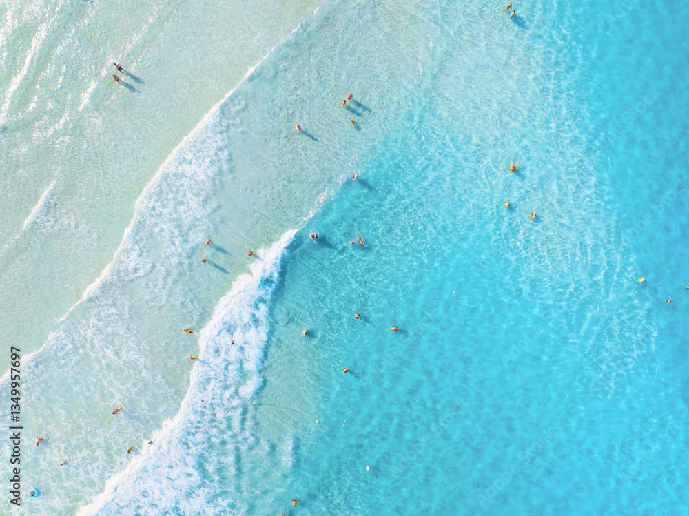 Wall mural aerial view on beach and people. vacation and adventure. top view from drone at beach and azure sea.