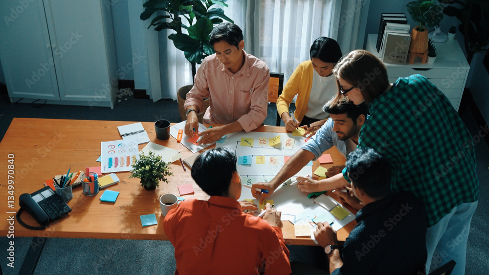 Poster close up of professional business team hands writing and putting sticky note on scrum task board. to