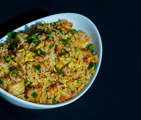 Prepared fried rice in a bowl, fried rice served in a white bowl, typical Asian fried rice dish, healthy homemade fried rice