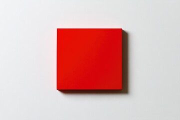 Bright red square contrasts with minimalistic background, emphas