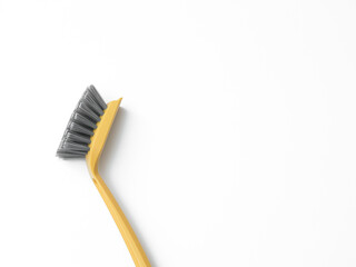 A dishwashing brush on a white background. Perfect for projects related to cleaning, household chores, kitchen accessories, and advertising household goods