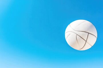Fototapeta premium White ball against a clear blue sky