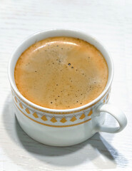 Hot Espresso Coffee with Foam in White Cup.