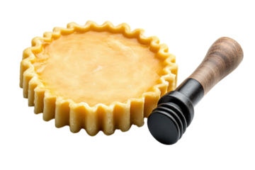 A delightful lemon tart promising sweet indulgence with a rustic wooden tamper alongside presented on a sleek dark backdrop for focused viewing.