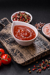 Red sauce or ketchup with salt and spices in ceramic sauce boat