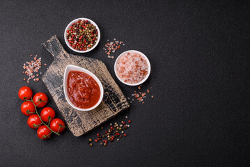 Red sauce or ketchup with salt and spices in ceramic sauce boat