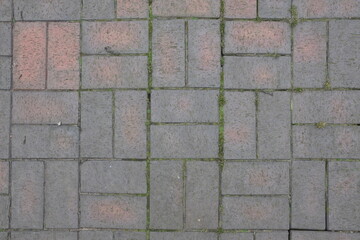 A brick walkway with a pattern of squares and rectangles