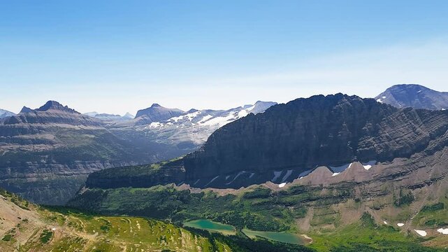 Establishing shot of Twin Lakes valley below Fusillade Mountain, in Glacier National Park, Montana.
