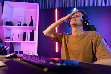 Host channel of gaming smart streamer playing online game to be failed with harder mission record by live steaming on media social for new strategy planning with team player at neon room. Pecuniary.