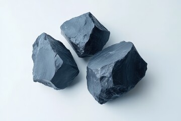 Naklejka premium Three dark textured rocks are presented on a white background