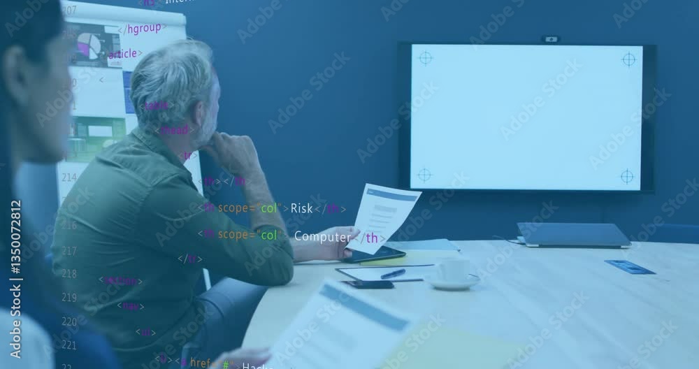 Poster in office, team reviewing documents with animation of code overlay on screen