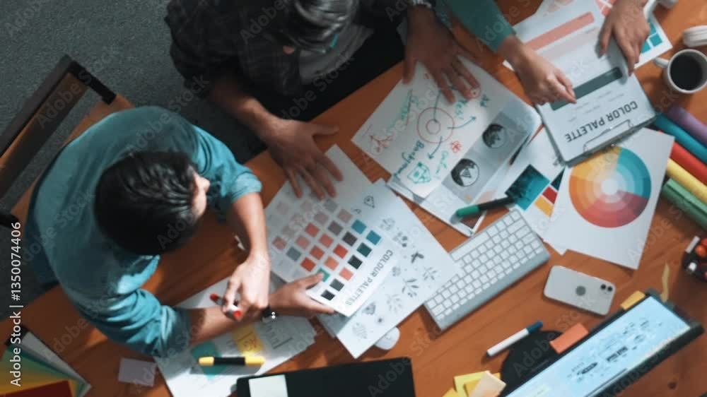 Poster top down aerial view of project manager looking at screen while designer writing idea. smart busines