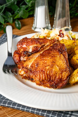 Appetizing baked chicken leg quarter.