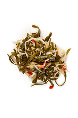Marinated seaweed salad with cabbage and red pepper, isolated on white background.