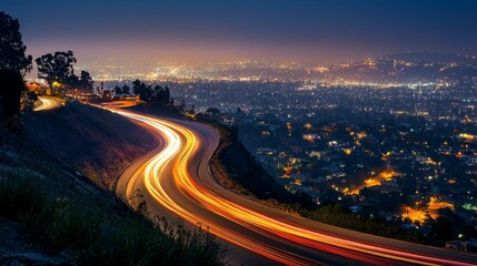 Fototapeta premium Nighttime Cityscape with Light Trails Along Winding Road