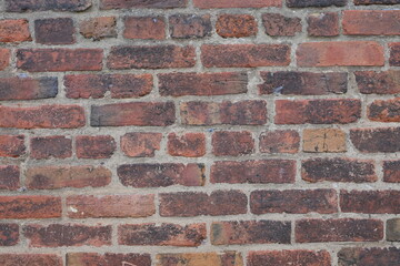 A brick wall with a red brick color