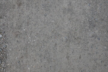 A grey and white background with a few rocks scattered around