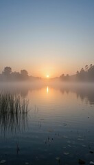 Fototapeta premium Serene Sunrise Over Tranquil Lake Surrounded by Misty Landscape