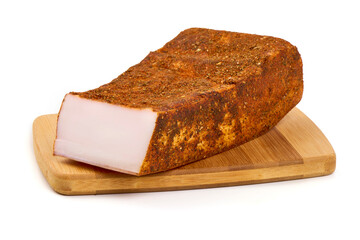 Cured pork fat with spices on a wooden board, isolated on white background.