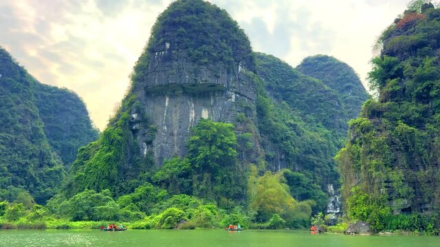 Trang An River Ninh Minh and Bai Dinh Mountain ranges in Vietnam only 3 hours drive from Hanoi. Beautiful winding river and large rising mountains. boats going through the caves in the river