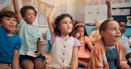 Lesson, kids and hands raised with question in classroom for quiz questions, knowledge or study...