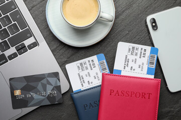 Travel agency. Flat lay composition with flight tickets and credit card on dark textured table