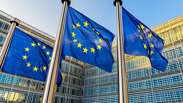 EU Flags Wave Above Modern Building.