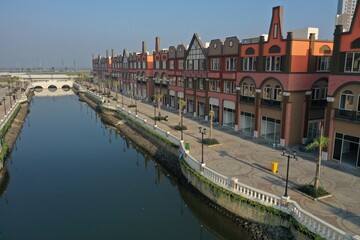 Fototapeta premium Aerial view of the shophouse area in the Pantai Indah Kapuk (PIK) area which is similar to Amsterdam, Netherlands