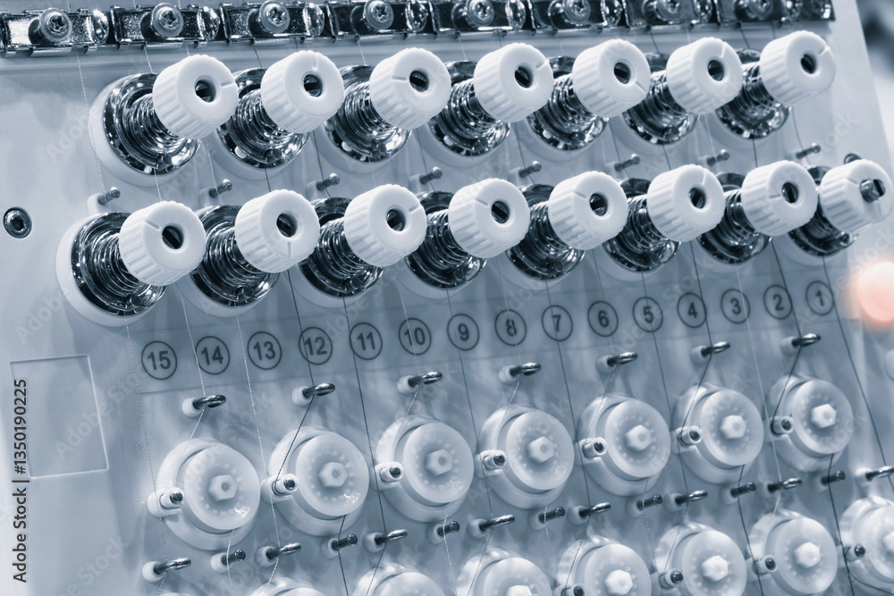 Leinwandbilder a machine is weaving a fabric with many threads. the machine is in a factory. concept of industry an