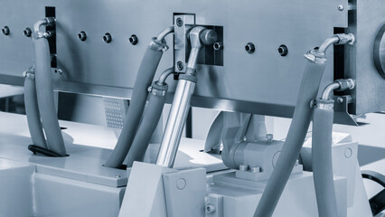 A machine with a lot of hoses and a lot of bolts. The bolts are silver and the hoses are blue