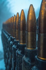Close-up view of bullets lined up against a backdrop of snowfall during winter time