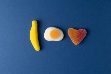 Gummy candy forming i love you on a blue background