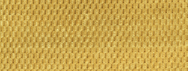 Texture yellow and golden fluffy fabric background with rhomboid pattern, macro. Abstract backdrop...