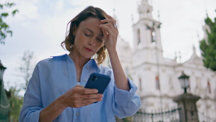Focused woman messaging mobile phone summer city closeup. Lady waiting in park