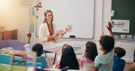 Teacher, children and hand raised in classroom for question, answer and quiz card for education at...