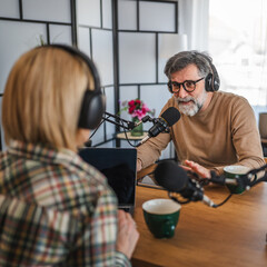 senior man guest in podcast answering on questions to woman host