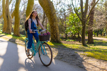Young woman riding bicycle in a sunny park