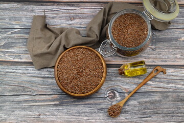 Flax seeds. Flaxseed powder in a wooden spoon. Standing on a Wooden background.