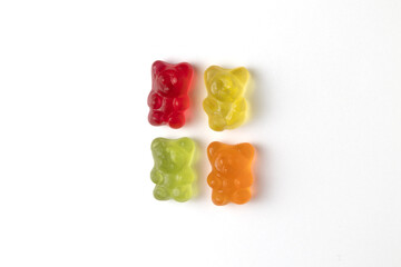 Four colorful gummy bears forming a square on white background